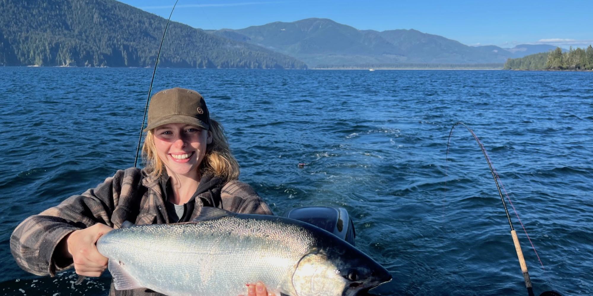 beautiful blonde woman showing salmon fishing rivers inlet bc on tidal charter boat